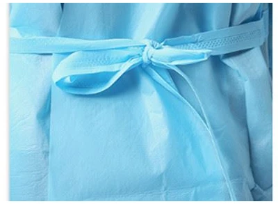 Adjustable lace up waist on disposable isolation gown
